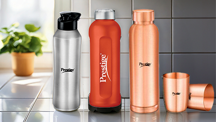 Three TTK Prestige reusable water bottles (black, red, and gold)