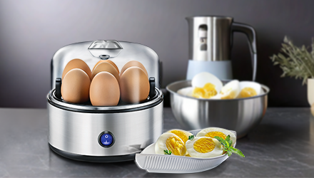 Silver egg cooker with eggs and boiled eggs