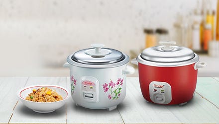 Two red and white Prestige rice cookers and a bowl of rice