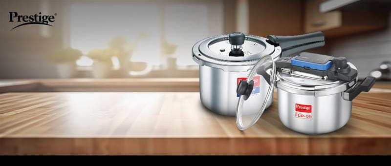 Prestige stainless steel pressure cookers displayed on a kitchen countertop, featuring the Flip-On model and classic design